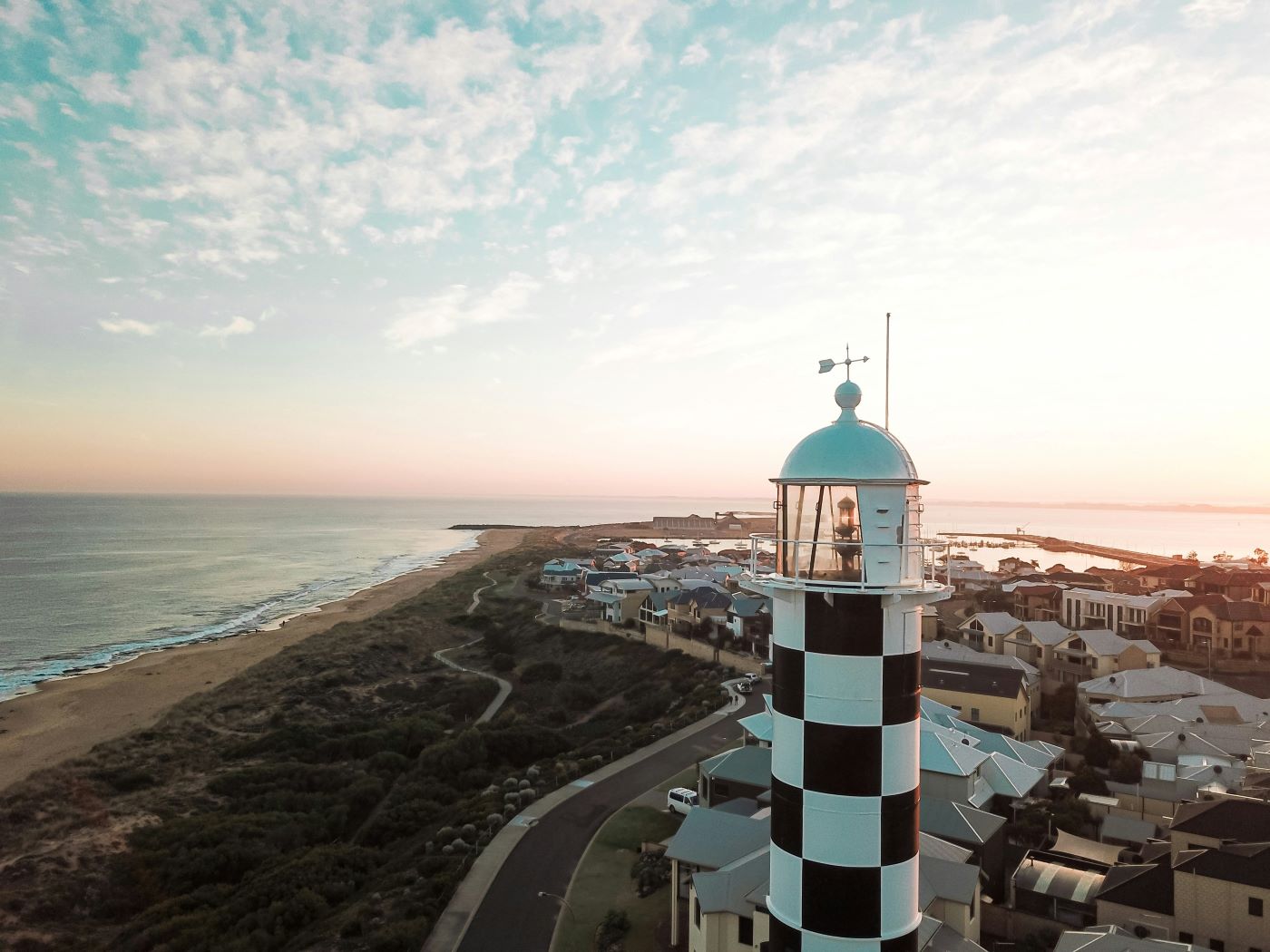 A lighthouse stands above the ocean.