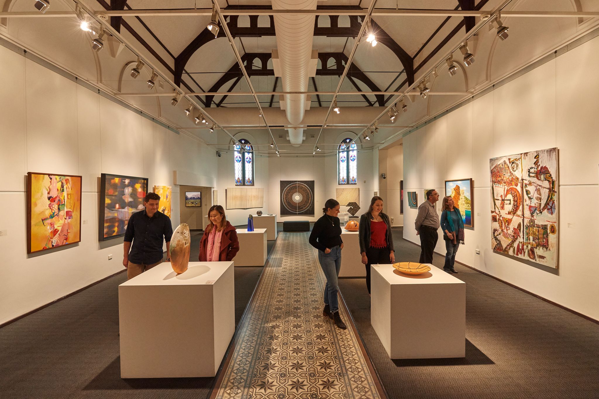 People admire artwork and sculptures at Bunbury Regional Art Gallery