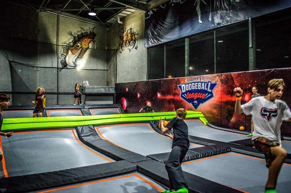 Children jumping on trampolines playing dodgeball